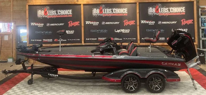 The Image of 2022 Caymas CX 21 PRO bass boat displayed indoors with promotional banners. - 1