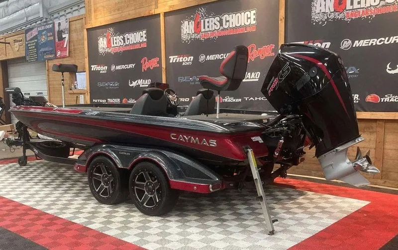 Slide: The Image of 2022 Caymas CX 21 PRO boat displayed indoors with promotional banners. - 2