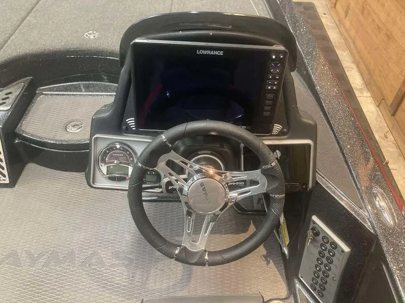 Slide: The Image of 2022 Caymas CX 21 PRO boat dashboard with Lowrance display and steering wheel. - 7