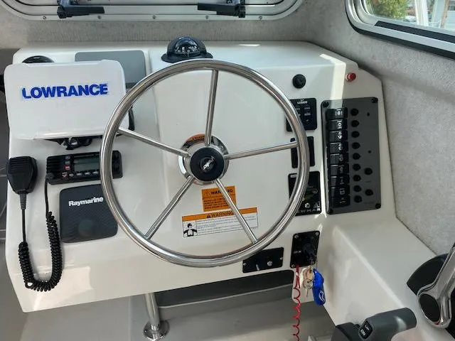 Slide: The Image of Helm of 2016 Parker 2120 Sport Cabin with Lowrance and Raymarine electronics. - 3