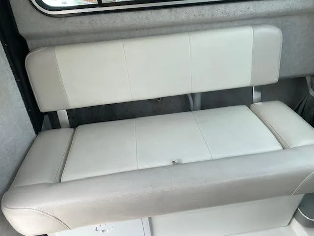 Slide: The Image of Interior seating of 2016 Parker 2120 Sport Cabin boat, featuring cushioned bench. - 5