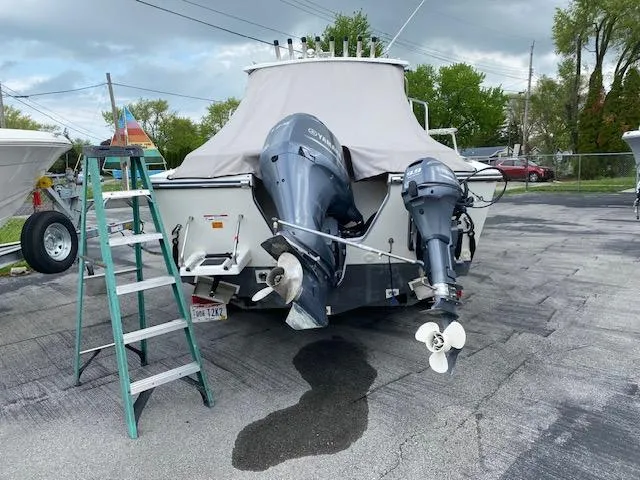 Slide: The Image of 2016 Parker 2120 Sport Cabin boat with dual outboard motors on a trailer. - 8