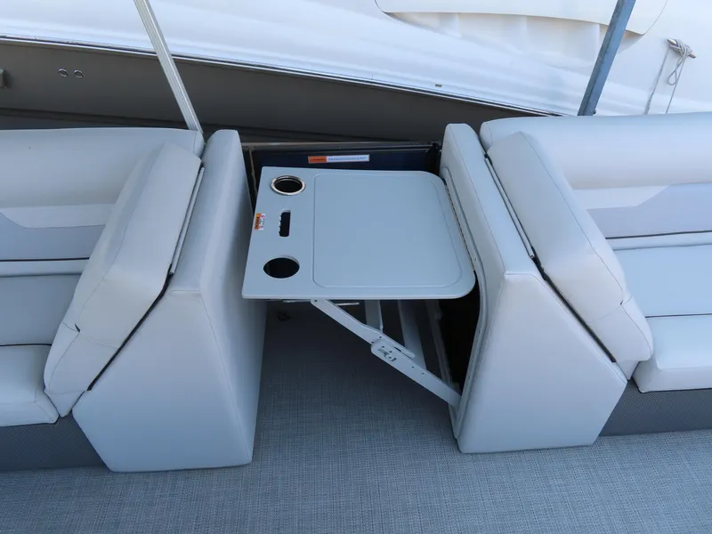 Slide: The Image of 2022 Crest Classic LX 220 boat interior with foldable table and cup holders. - 10