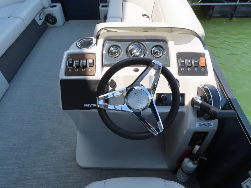 Slide: The Image of Steering console of 2022 Crest Classic LX 220 boat with modern controls and gauges. - 14