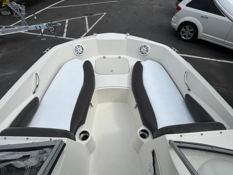 Slide: The Image of 2019 Stingray 191 DC boat interior with seating and cup holders. - 12