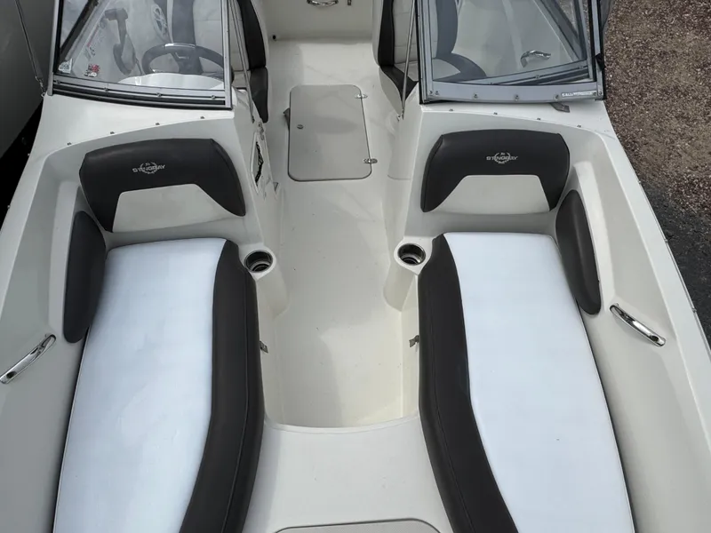 Slide: The Image of 2019 Stingray 191 DC boat interior with dual seating and cup holders. - 14