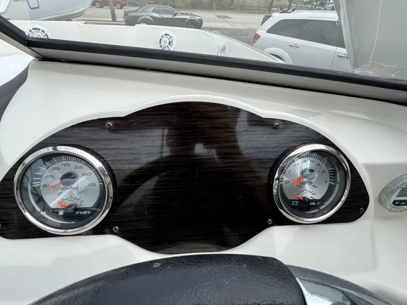Slide: The Image of Dashboard of a 2019 Stingray 191 DC boat with gauges and steering wheel. - 19