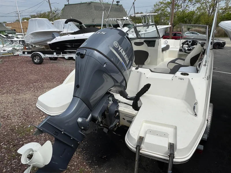 Slide: The Image of 2019 Stingray 191 DC boat with Yamaha outboard motor, parked on a trailer. - 3