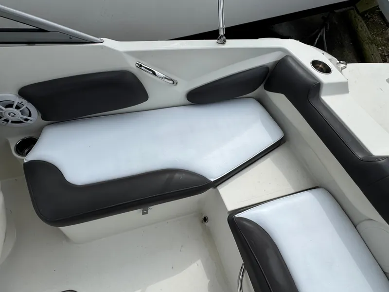 Slide: The Image of 2019 Stingray 191 DC boat interior with white and black seating. - 6