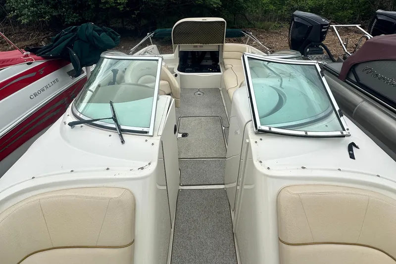 Slide: The Image of 2001 Sea Ray 240 Sundeck boat interior with open windshield and seating. - 12