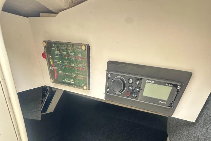 Slide: The Image of 2001 Sea Ray 240 Sundeck interior with control panel and audio system. - 16