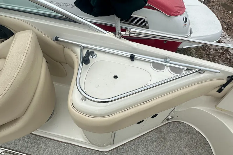 Slide: The Image of 2001 Sea Ray 240 Sundeck interior with beige seating and cup holders. - 21