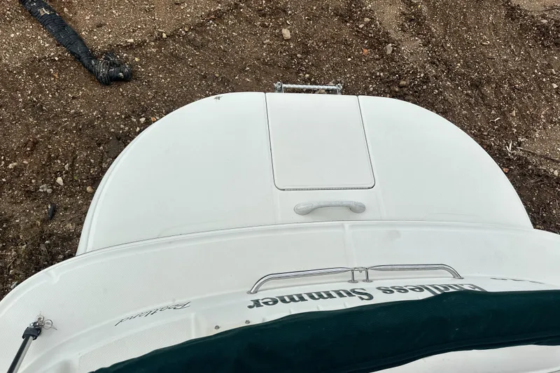 Slide: The Image of 2001 Sea Ray 240 Sundeck boat, top view, on dry land. - 25