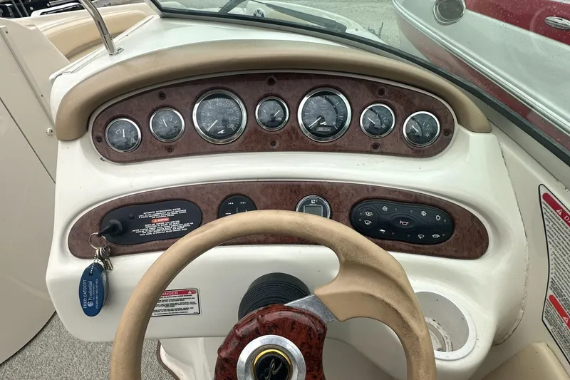 Slide: The Image of Dashboard of a 2001 Sea Ray 240 Sundeck boat with gauges and steering wheel. - 5