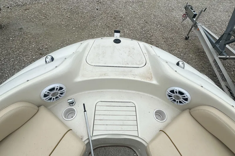 Slide: The Image of 2001 Sea Ray 240 Sundeck boat interior with seating and speakers. - 8