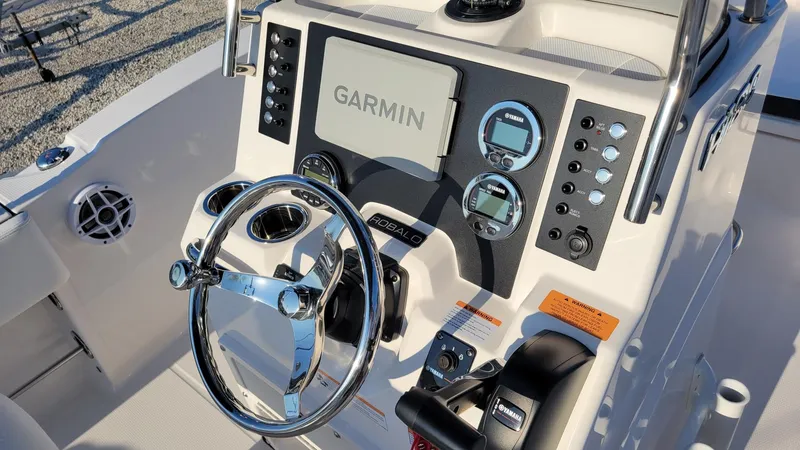 Slide: The Image of 2024 Robalo R180 Center Console dashboard with Garmin display and steering wheel. - 10