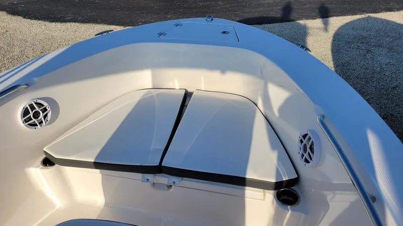 Slide: The Image of 2024 Robalo R180 Center Console boat interior with cushioned seating and speakers. - 11