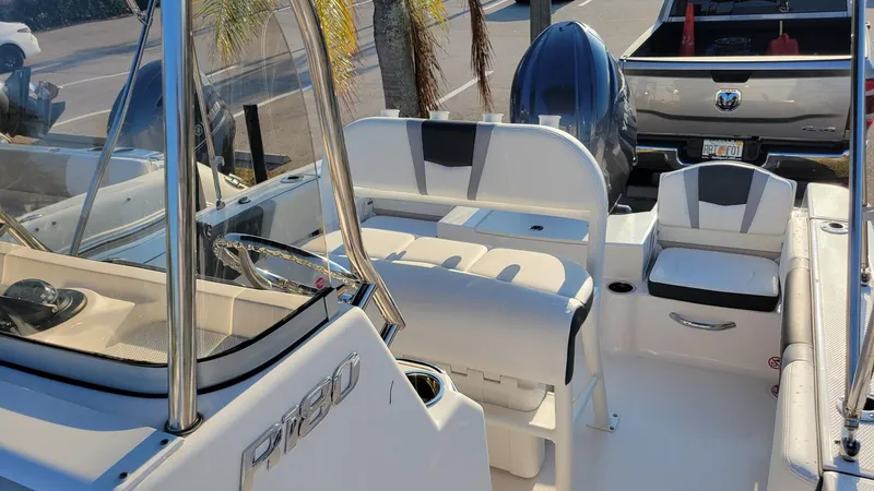Slide: The Image of 2024 Robalo R180 Center Console boat interior with seating and console view. - 14