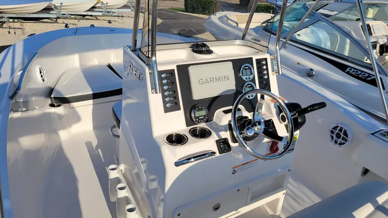 Slide: The Image of 2024 Robalo R180 Center Console boat with Garmin navigation system and sleek interior design. - 16