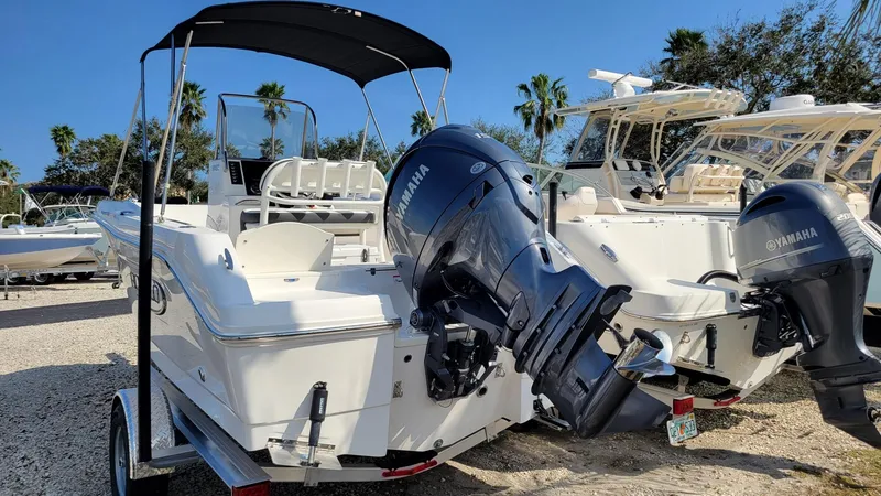 Slide: The Image of 2024 Robalo R180 Center Console boat with Yamaha outboard motor, parked on a trailer. - 3