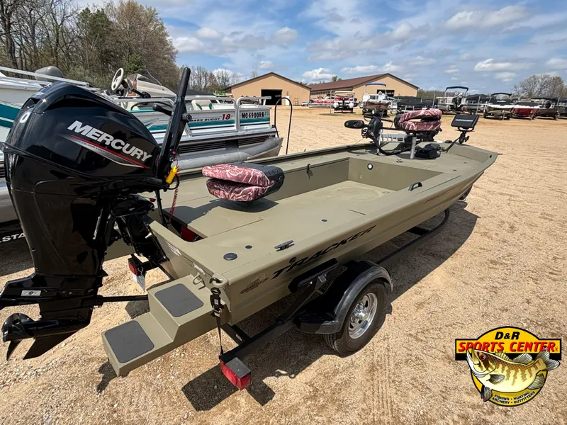 Slide: The Image of 2024 Tracker Grizzly 1654 T Sportsman boat with Mercury engine at dealership. - 2