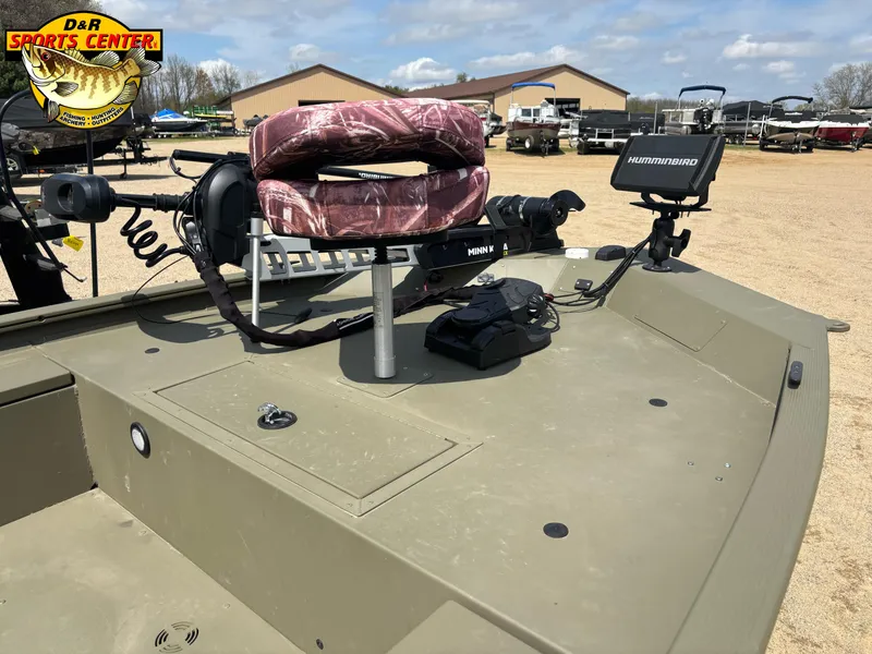Slide: The Image of 2024 Tracker Grizzly 1654 T Sportsman boat with fishing equipment and camo seat. - 5