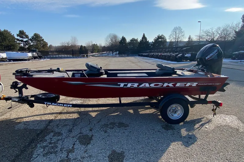 The Image of 2025 Tracker Panfish 17 boat on trailer, red exterior, parked outdoors. - 0