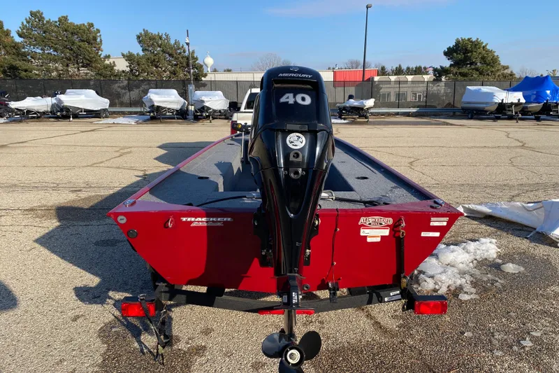 Slide: The Image of 2025 Tracker Panfish 17 boat with Mercury 40 engine in parking lot. - 2