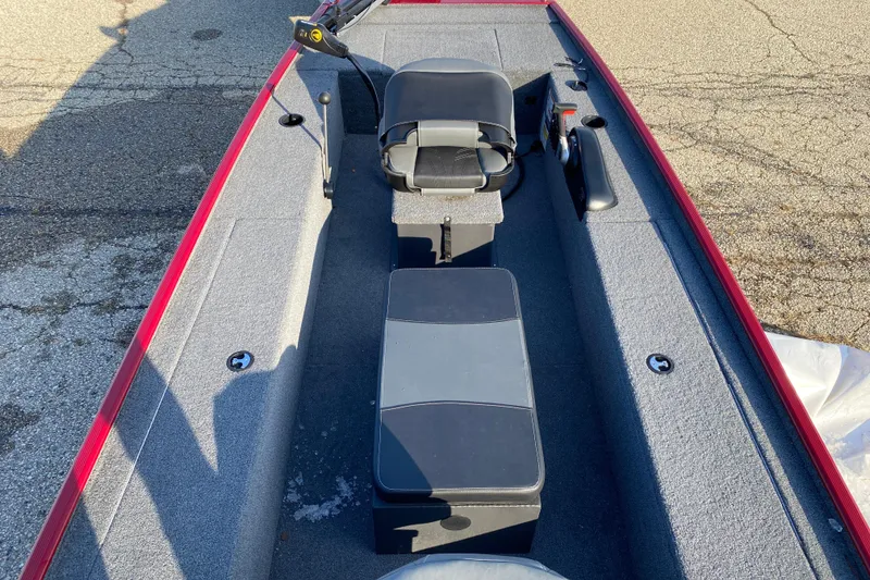 Slide: The Image of 2025 Tracker Panfish 17 boat interior with seating and controls, featuring a red trim. - 3
