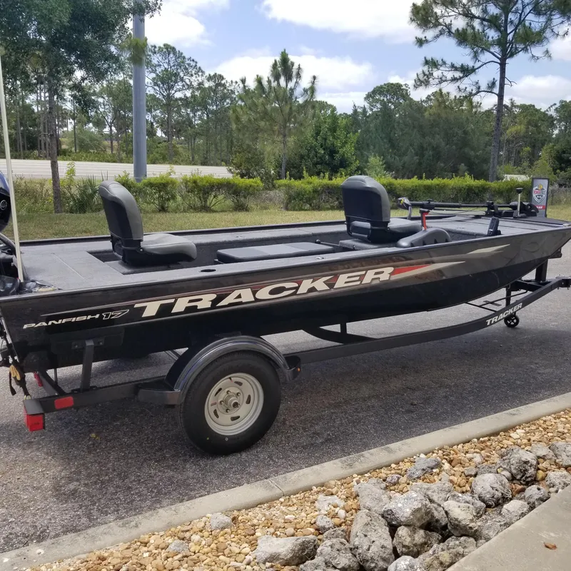 The Image of 2025 Tracker Panfish 17 boat on trailer, parked outdoors with trees in background. - 0