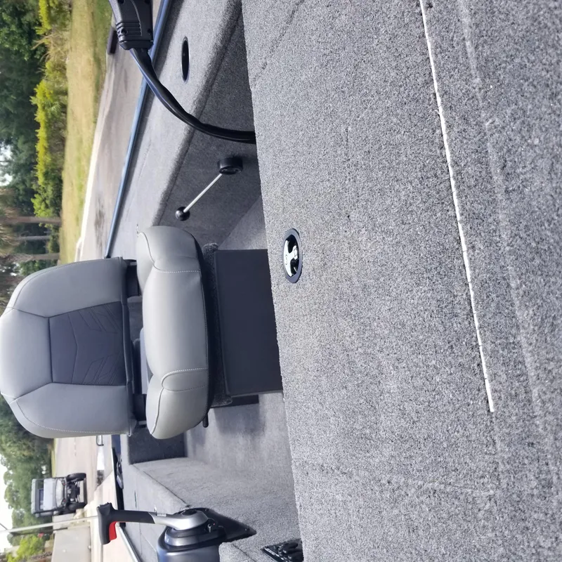 Slide: The Image of 2025 Tracker Panfish 17 boat interior with gray seating and carpeted flooring. - 4