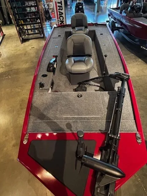 Slide: The Image of 2025 Tracker Panfish 17 boat with dual seats and trolling motor in showroom. - 2