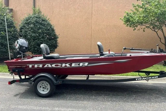 The Image of 2025 Tracker Panfish 17 boat on trailer, red exterior, parked outdoors. - 0