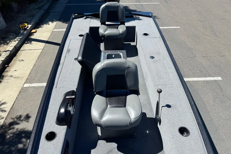 Slide: The Image of 2025 Tracker Panfish 17 boat interior with gray seating and fishing rod holders. - 14