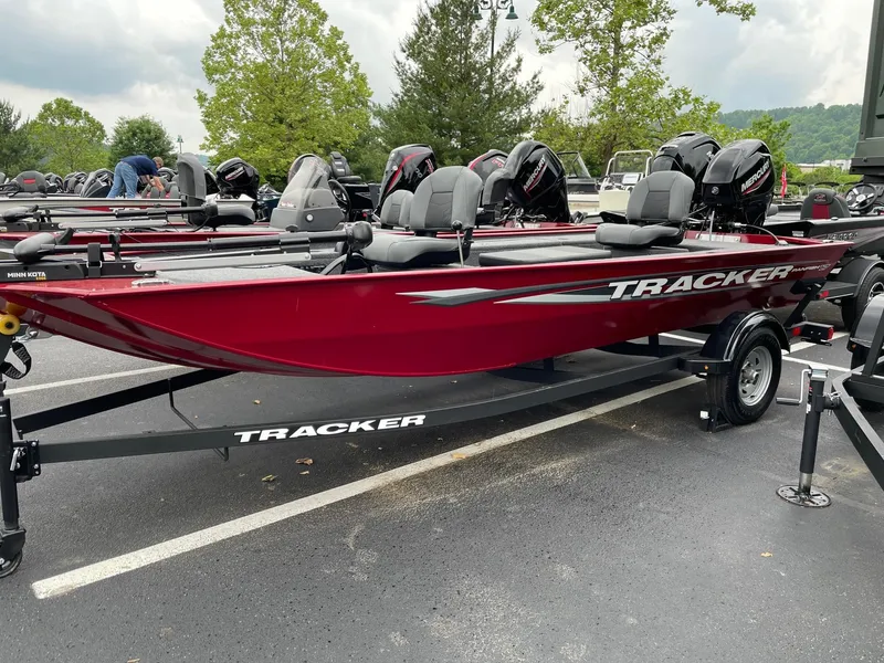The Image of 2025 Tracker Panfish 17 boat, red color, parked on trailer in outdoor setting. - 0