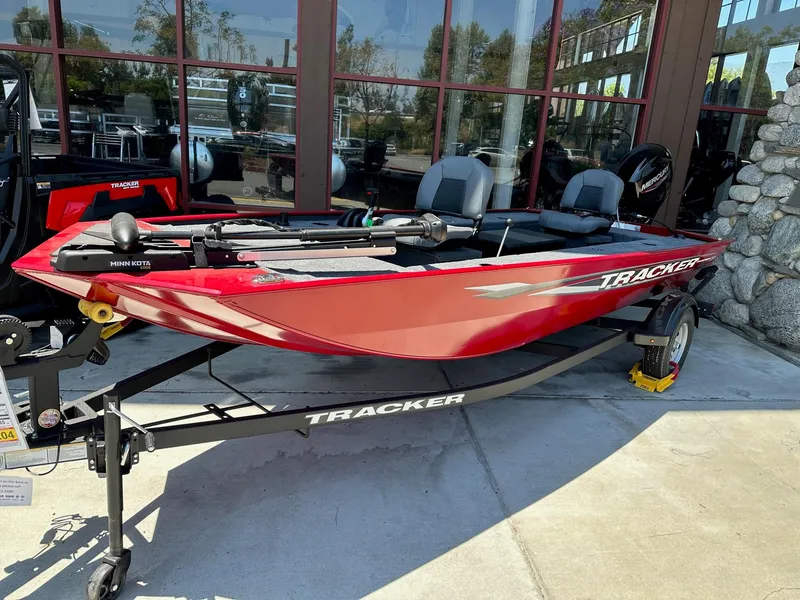 The Image of 2025 Tracker Panfish 17 boat in vibrant red on a trailer, displayed outdoors. - 0