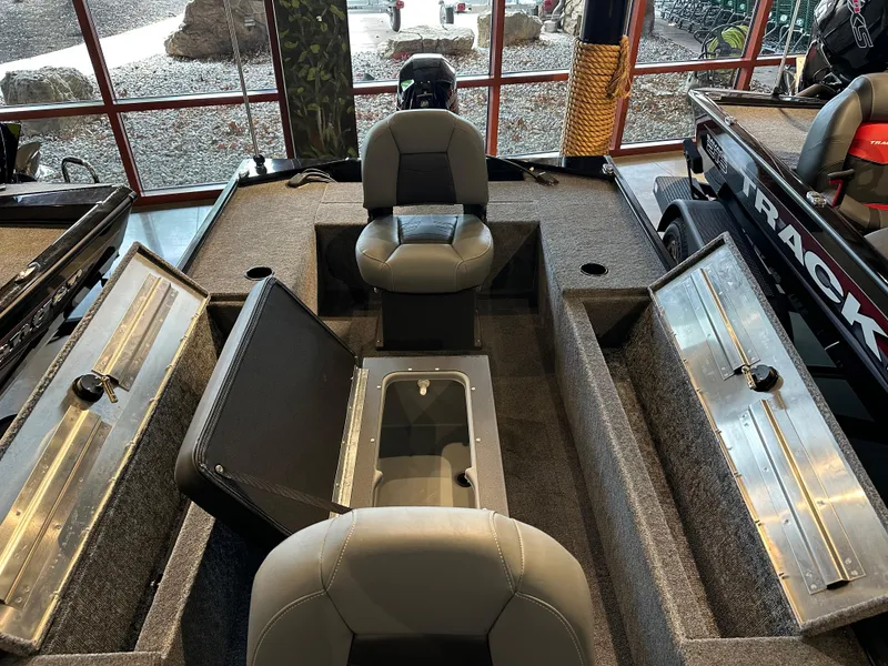 Slide: The Image of 2025 Tracker Panfish 17 boat interior with seating and storage compartments. - 2