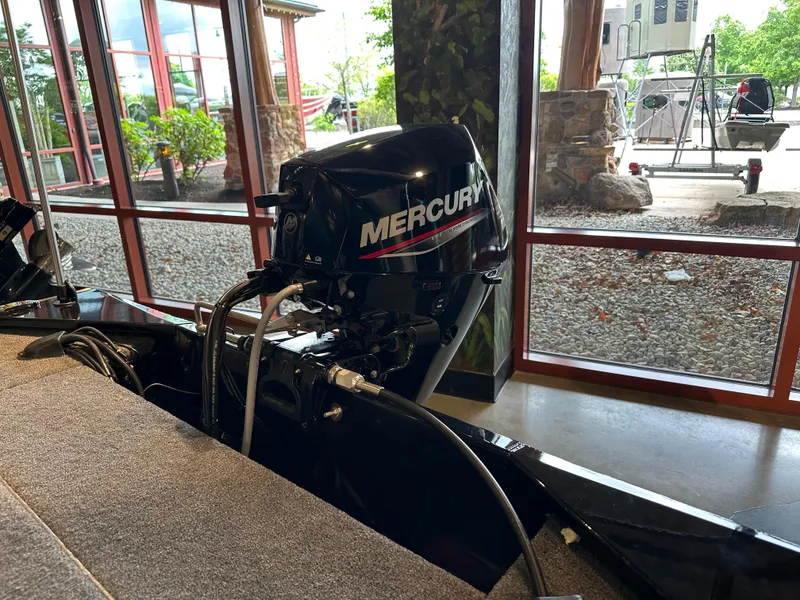 Slide: The Image of 2025 Tracker Panfish 17 boat with Mercury outboard motor in showroom. - 5