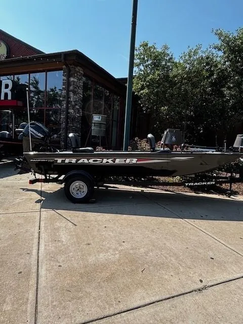 The Image of 2025 Tracker Panfish 17 boat on trailer, parked outside a building. - 0