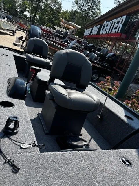 Slide: The Image of 2025 Tracker Panfish 17 boat interior with seating, displayed at a boat center. - 2