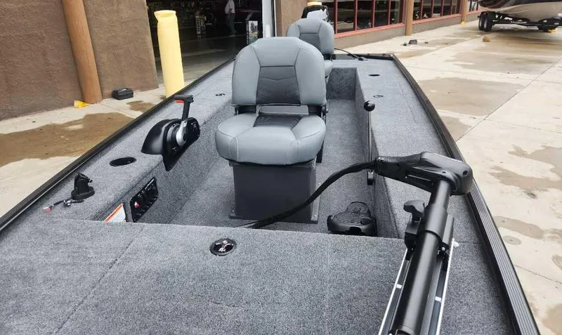 Slide: The Image of 2025 Tracker Panfish 17 boat interior with gray seating and control panel. - 2