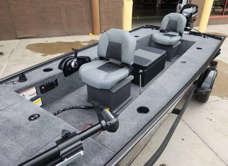 Slide: The Image of 2025 Tracker Panfish 17 boat with gray seating and modern controls. - 3