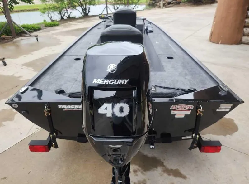 Slide: The Image of 2025 Tracker Panfish 17 boat with Mercury 40 outboard motor, parked on concrete. - 6