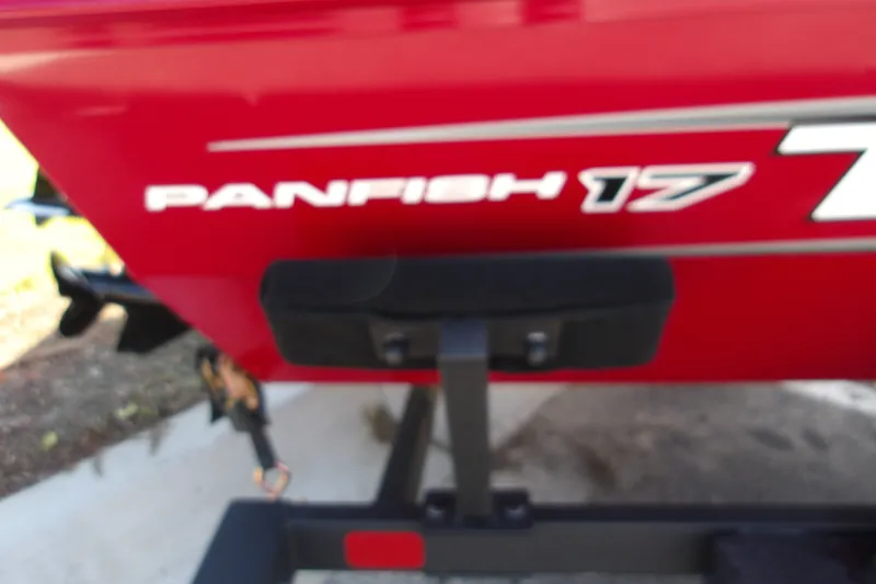 Slide: The Image of Red 2025 Tracker Panfish 17 boat on trailer, close-up view of model name. - 15