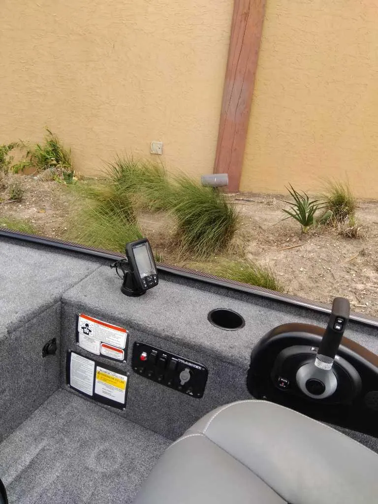 Slide: The Image of 2025 Tracker Panfish 17 boat interior with control panel and seating. - 2