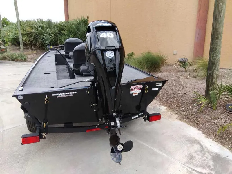 Slide: The Image of 2025 Tracker Panfish 17 boat with Mercury 40 engine, parked outdoors. - 5