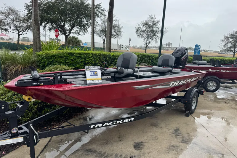 The Image of 2025 Tracker Panfish 17 boat on trailer, displayed outdoors in a rainy setting. - 0