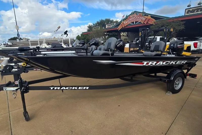 The Image of 2025 Tracker Panfish 17 boat on trailer, displayed outdoors at dealership. - 0