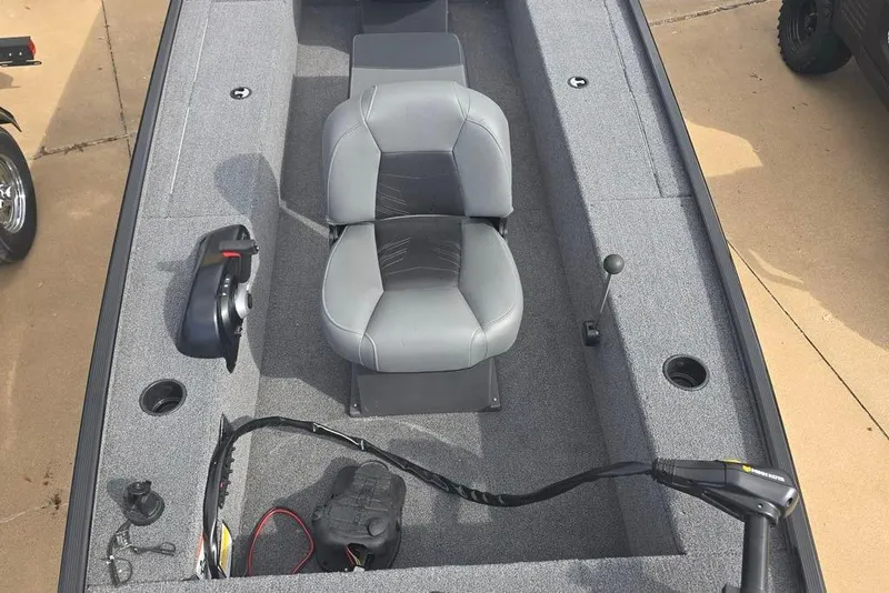 Slide: The Image of 2025 Tracker Panfish 17 boat interior with gray seating and control panel. - 2