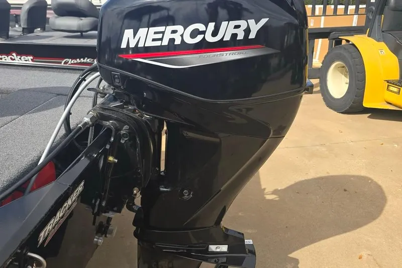 Slide: The Image of 2025 Tracker Panfish 17 with Mercury FourStroke outboard motor, parked on concrete. - 4